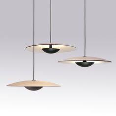 three suspended lights in different shapes and sizes