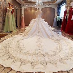 the wedding dress is on display in front of mannequins wearing gowns