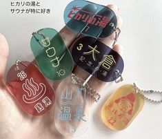 a hand holding several different colored tags on it's fingers with the words written in japanese