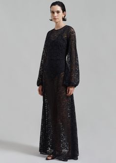 Color: Black Lightweight sheer floral lace Relaxed fit Maxi length Crew neck Long balloon sleeves Bodysuit beneath Deep v-back Back tie Concealed back zip closure Lined 95% Polyester 5% Elastane Machine Wash Cold By ROTATE Birger Christensen. Imported All Black Attire, Long Lace Dress, Bella Barnett, Rotate Birger Christensen, Black Attire, Vegas Elopement, Birger Christensen, Black Tank Dress, Cotton Shirt Dress