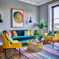 a living room filled with furniture and colorful rugs on top of a hard wood floor