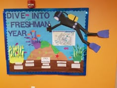 a bulletin board with an image of a scuba diver on it's side and words dive into freshman year below