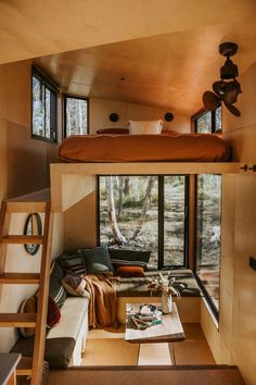 there is a loft bed in the middle of this room with a ladder leading up to it