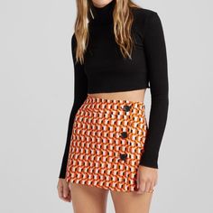 Small Never Worn Patterned Bershka Skirt Black Retro Mini Skirt For Fall, Orange Fitted Retro Mini Skirt, Fitted Retro Orange Mini Skirt, Chic Fitted Orange Mini Skirt, Orange Retro Mini Skirt, Orange Mini Length Lined Skirt, Trendy Orange Skirt For Fall, Retro Orange Mini Skirt, Orange Lined Mini Skirt For Party