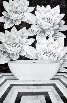 a white bath tub sitting on top of a black and white tiled floor next to a wall