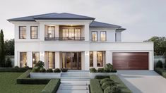 a white two story house with lots of windows and plants on the front lawn area