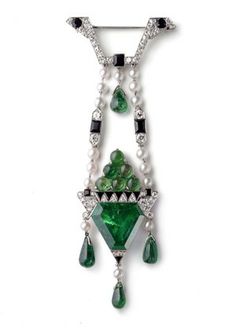 This Cartier brooch dating from 1913 was inspired by the Ballets Russes and is set with round old-cut diamonds, a bevelled 11.90ct emerald, ...