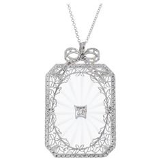 Quartz and diamond pendant necklace. Rectangle quartz with an old mine diamond accent set in a filigree open work 14k white gold design, with a 14k white gold chain. 1 rectangle quartz 1 old mine diamond I, SI approx. .3cts 14k white gold 8.9 grams Chain: 18 Inches Camphor Glass Jewelry, Gold Filigree Necklace, Filigree Pendant Necklace, Filigree Necklaces, Jewelry Accessories Ideas, Filigree Pendant, Diamond Quartz, Diamond Pendant Necklace, Gold Design