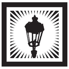 a black and white silhouette of a street light with rays coming out of it's center