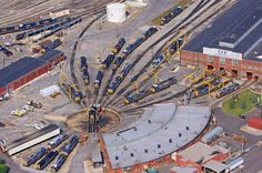 an aerial view of a train yard with trains on the tracks