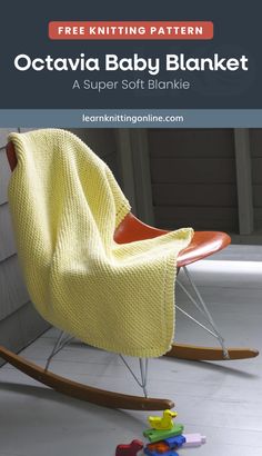 a baby blanket sitting on top of a rocking chair