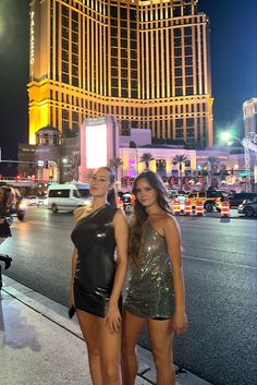 two beautiful women standing next to each other in front of the las vegas hotel and casino