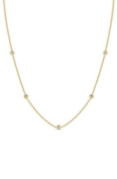 Five bezel-set diamonds appear to float along this dainty chain choker made of 14-karat gold. 14 1/8" length; 2" extender; 1/8" station diameter Lobster clasp closure Total diamond weight: 0.15ct. Color: F-G Clarity: SI2 14k gold/diamond Made in the USA Diamond Guide Yellow Gold Bezel Setting Station Necklace, Zoe Chicco, Diamond Guide, Dainty Chain, Bezel Set Diamond, Station Necklace, Chain Choker, Bezel Setting, Womens Jewelry Necklace