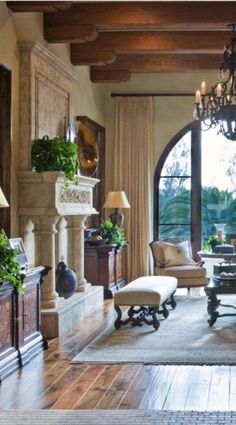 a living room with an arched window and wooden flooring is pictured in this image