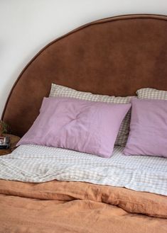 a bed with two pillows on top of it