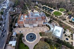 an aerial view of a large building in the middle of a park