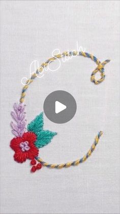 the video is showing how to make an embroidered bracelet with flowers and leaves on it