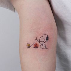 a small tattoo on the arm of a person with a dog and fire hydrant