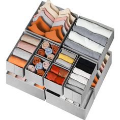 an organized drawer with folded towels and scarves in it on a white background photo