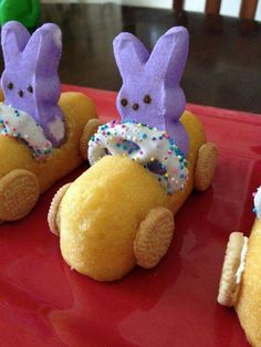 three little bunnies in the shape of cars with bunny ears on them sitting on a red plate