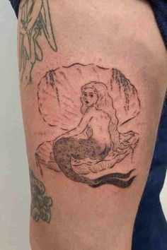 a woman with a tattoo on her thigh