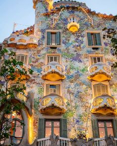 the facade of a building with many windows and balconies on it's sides