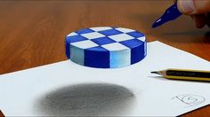 a blue and white cake sitting on top of a piece of paper next to a marker