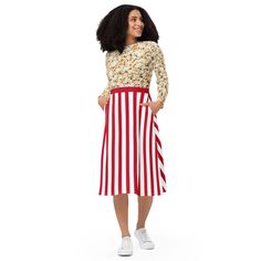 a woman standing wearing a red and white striped skirt with buttons on the side, in front of a white background