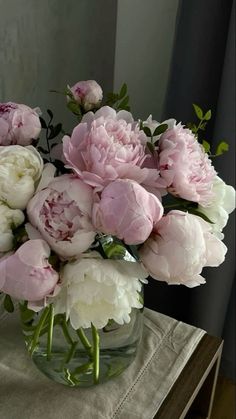 a vase filled with pink and white flowers