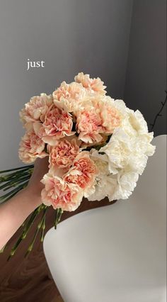 a bouquet of flowers sitting on top of a white chair