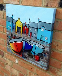 a painting on the side of a brick wall with two boats in front of it