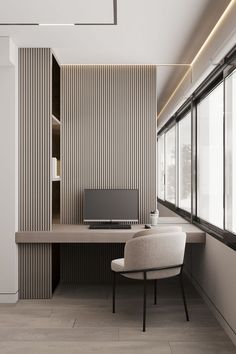 a desk with a computer on top of it in front of a window next to a chair