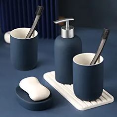 three pieces of bathroom accessories on a blue surface