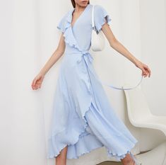 Embrace effortless elegance with our Muslin Cotton Wrap Dress, a perfect blend of comfort and style. This short-sleeved dress with playful ruffles offers a breezy, relaxed fit that flatters any body type. The gauze V-neck design adds a touch of feminine charm, making it an ideal pick for both casual outings and special events. The maxi length ensures a graceful silhouette, while the wrap style allows for adjustable sizing, ensuring a custom fit for all. Our dress, crafted in a beautiful shade of pastel blue, is a must-have wardrobe essential for the fashion-forward woman. Its lightweight fabric is perfect for sunny days or layered styling for cooler evenings. * All clothing made from European muslin (100% cotton) * OEKO-TEX certified fabric (no harmful chemicals used in production) * From Short Sleeves Dress, Cotton Wrap Dress, Wrap Dress Short, Dress Short Sleeves, Dress With Ruffles, Dressed To The Nines, Layer Style, Sleeves Dress, Charm Making