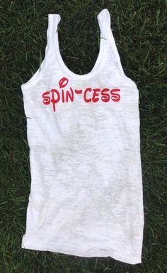 a white tank top that says spinces on the front and red writing on the back