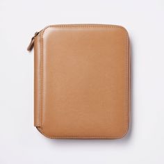 a tan leather case sitting on top of a white surface