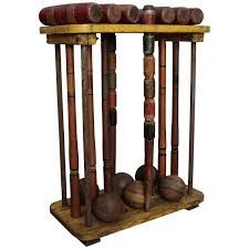 a wooden rack with many different types of baseballs and bats on it's sides