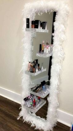 a white feathered shelf with cosmetics on it