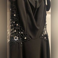 a black dress with beaded details on it