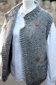 a mannequin wearing a gray knitted vest with buttons on the front and back