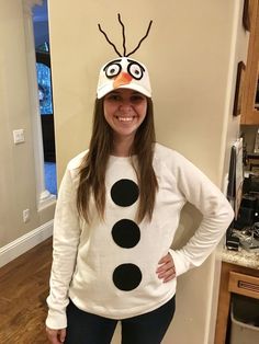 a girl wearing a snowman hat and sweater