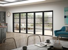 an open kitchen and living room with sliding glass doors