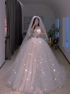 a woman in a white wedding dress with stars on it