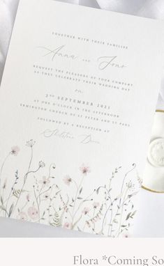 a wedding card with flowers on it and the words flora coming soon written in white ink