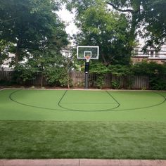 an outdoor basketball court in the backyard