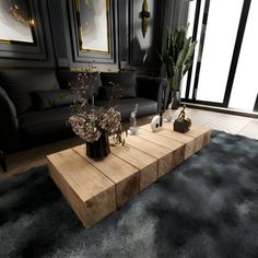 a living room filled with black furniture and lots of plants on top of a wooden coffee table