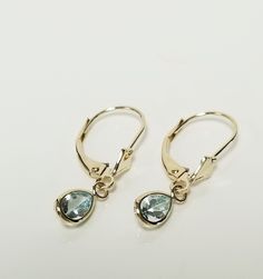 "Thanks for shopping our vintage estate store. We tend to sell well below wholesale and truly hope you enjoy all of our items. Many of the items are one of a kind, so please enjoy scrolling through the pictures and hopefully something will catch your eye. Brown spots are from camera or reflections. Nice estate 14k yellow gold natural .50ct aquamarine tear drop lever back earrings. Length: 7/8\" Width: 1/4\" 4.5mm Weight: .96 gram Gem: 6mm by 4mm Beautiful earrings, marked 14k." Classic Teardrop Lever Back Jewelry, Teardrop Lever Back Jewelry For Anniversary, Yellow Gold 14k Pear-shaped Teardrop Earrings, Gold Aquamarine Teardrop Jewelry, Handmade Gold Teardrop Earrings In 14k Gold-filled, Handmade Gold Teardrop Earrings 14k Gold-filled, 14k Gold-filled Teardrop Natural Stone Earrings, Brown Spots, Aquamarine