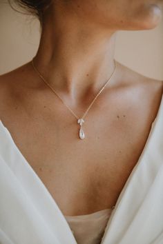 Eilat Necklace  A trio of crystal petals and a pear shaped pendant adorn this bridal drop necklace. The perfect elegant addition to your bridal look and the perfect bridesmaid gift. Available in Gold, Rose Gold and Silver.  Dimensions: Chain is 15.5" long and can extend to 18" with adjustable closure. Pendant is 2.5 cm long and 1 cm wide. Our earrings, necklaces and bracelets are lead, nickel and cadmium free. These pieces are hypo-allergenic and are safe for sensitive skin and ears. Each order Wedding Necklace Gold, Crystal Wedding Necklace, Gold Necklace Wedding, Gold Leaf Pendant, Gold Bridal Necklace, Pear Shaped Pendant, Bride Necklace, Eilat, Wedding Necklaces