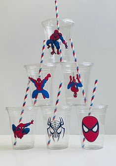 a stack of cups with spiderman drinking straws