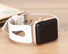 "Recycled smart watch band for daily use. Get a gift for yourself, for them!  Compatibility  * For Apple Watch 38/40/42/44/45 mm * Series 9-8-7-6-5-4-3-2-1-SE  Hardware Colors  -Apple Watch- * Rose Gold * Gold * Black * Silver * Space Grey -Fitbit Versa 1, 2, Lite- * Rose Gold * Gold * Black * Silver  Sizes  * Fits wrists between: 155mm-200mm / 6\"-7.80\" !! Request extra holes if needed please !!  Personalization  * Have your band engraved!  Shipping  * North America / 1-3 business days * Europa / 1-3 business days * Asia Pacific / 3-5 business days Have a second thought? Please contact me :)" Modern White Leather Strap Apple Watch Band, Modern White Leather Apple Watch Band, Modern White Apple Watch Band For Everyday Use, White Adjustable Watch Accessories For Everyday Use, White Watch Bands With Bracelet Strap, White Leather Strap Watch Bands For Gift, White Leather Strap Watch Band As Gift, Modern White Watch Accessories As Gift, White Rectangular Watch Accessories For Gifts